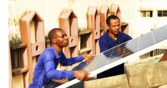The research team fitting a solar panel.
